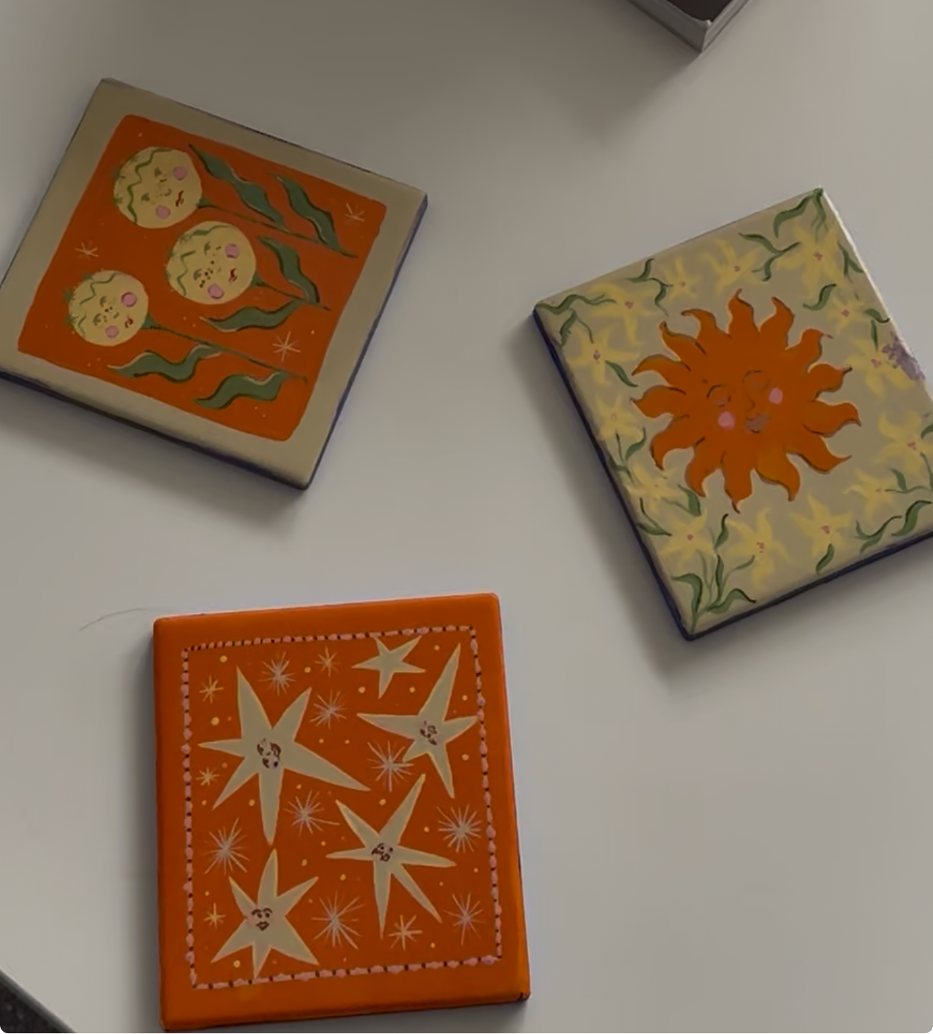 Hand Painted Square Ceramic square coasters. Painted in whimsical and floral motifs.