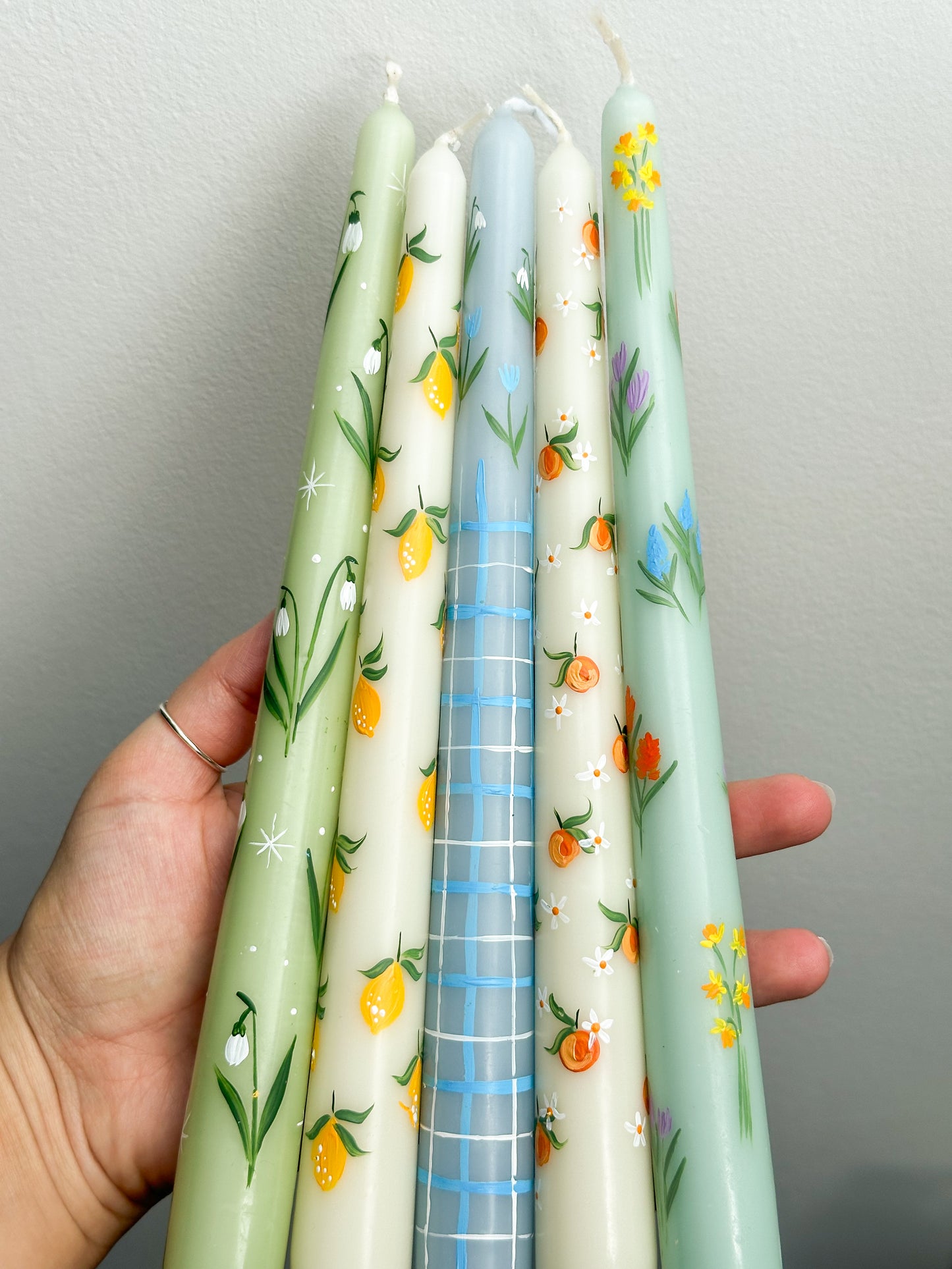 Spring hand painted candles in blue, yellow and green tones.
